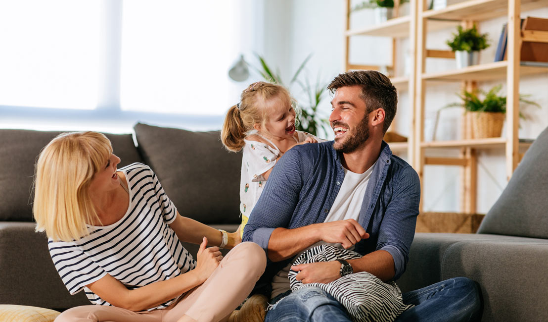 Laughing family in comfortable home